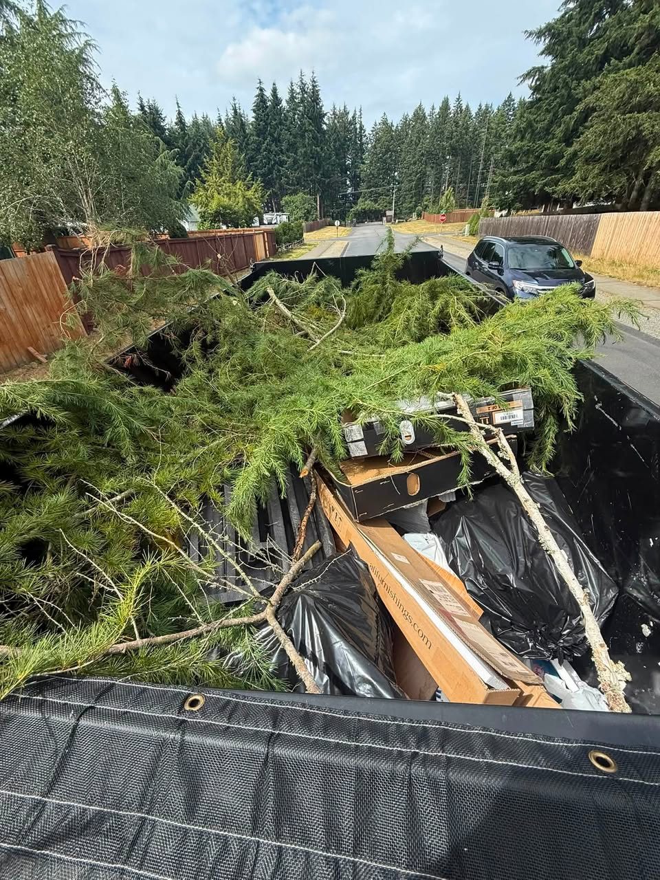 Junk Junk Begone trailer hauling branches and yard debris